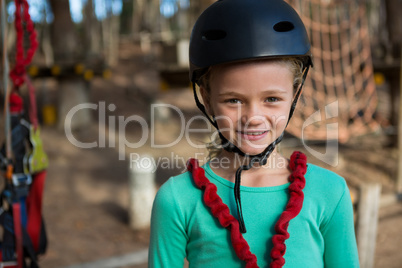 Portrait of little girl wearing helmet and harness