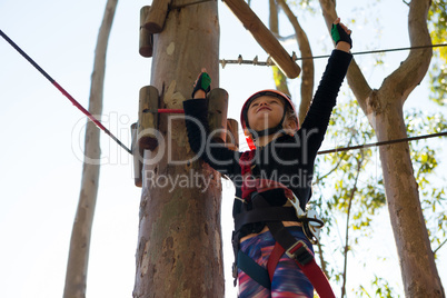 Little girl wearing helmet raising her hands towards sky