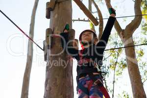 Little girl wearing helmet raising her hands towards sky