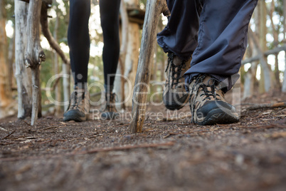 Feet of woman and man hiker hiking in forest