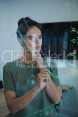 Female executive writing on glass