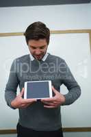 Executive holding digital tablet in the office