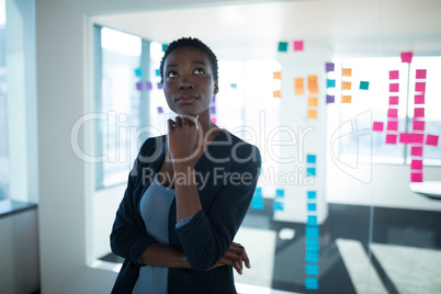 Female executive standing in office