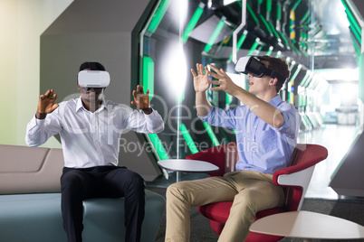 Male executives using virtual reality headset