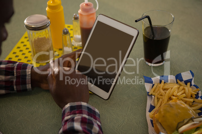 Man using digital tablet in restaurant