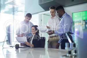 Executives discussing over graph at desk