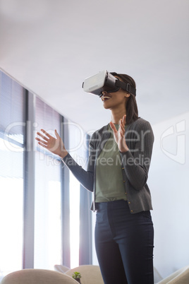 Female executive using virtual reality headset