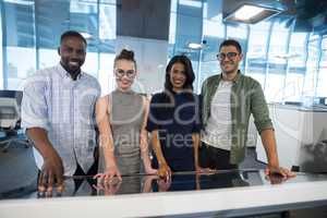 Portrait of business executives touching digital screen