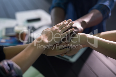 Close-up of business executives forming hand stack