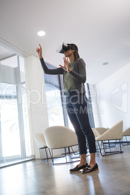 Female executive using virtual reality headset