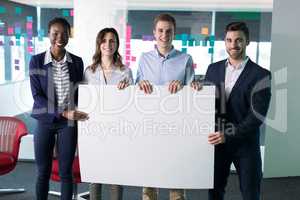 Portrait happy executives holding a blank banner