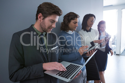 Team of business people using electronic devices