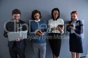 Team of business people using electronic devices