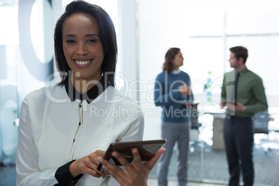 Female executive using digital tablet in office Female executive using digital tablet in office