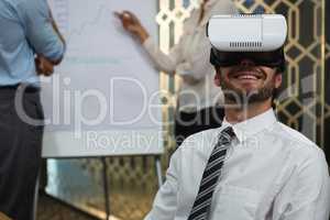 Businessman using virtual reality headset in conference room