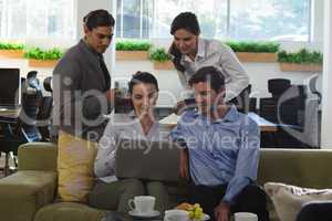 group of executive discussing over laptop