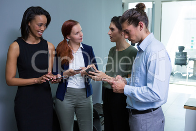 Executives using mobile phone in the office