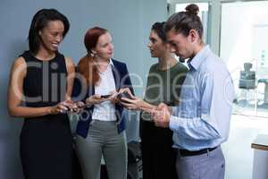 Executives using mobile phone in the office