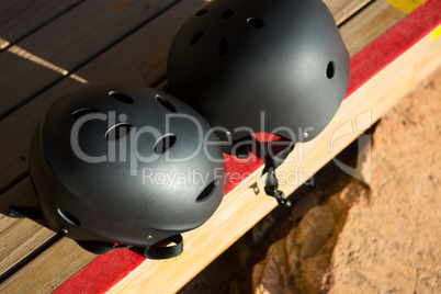 Two safety helmet placed on wooden table on a sunny day