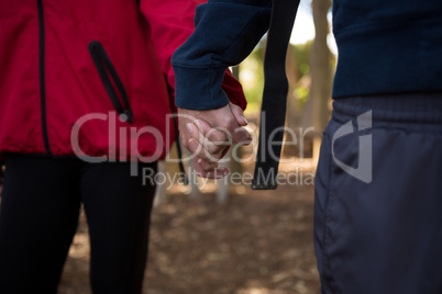Man and woman holding there hands in the forest