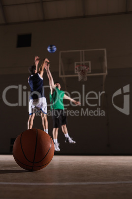 Two players playing basketball