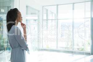 Female executives looking through transparent glass