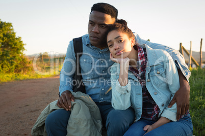 Couple sitting together near dirt track