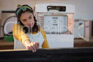 Woman filling petrol in car at petrol pump