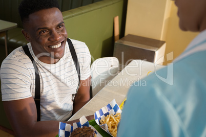 Waitress serving breakfast to customer