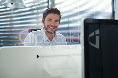 Male executive looking at camera in the office