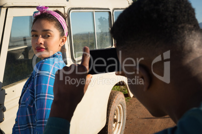 Man clicking picture of woman with mobile phone