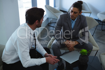 Businessmen interacting with each other in lobby