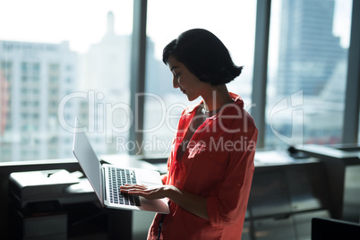 Female executive using laptop