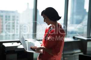 Female executive using laptop