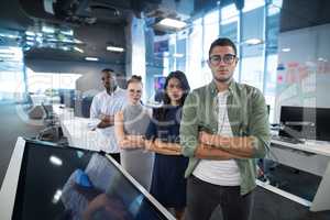 Portrait of business executives standing with arms crossed