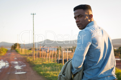 Man walking on dirt track at countryside