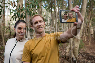 Hiker couple taking selfie in the forest