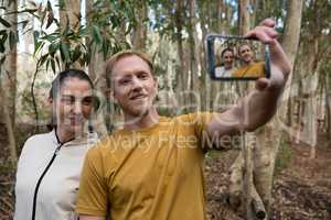 Hiker couple taking selfie in the forest