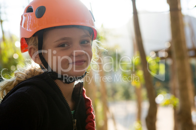 Portrait of little girl wearing helmet in the forest