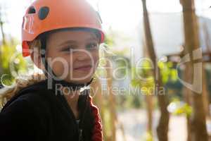 Portrait of little girl wearing helmet in the forest