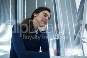 Female executive relaxing at desk