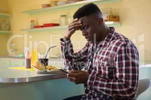 Man using mobile phone in restaurant