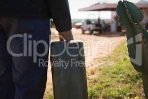 Man holding a petrol can on a sunny day