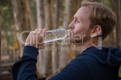 Athletic man drinking water from a bottle