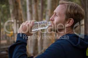 Athletic man drinking water from a bottle