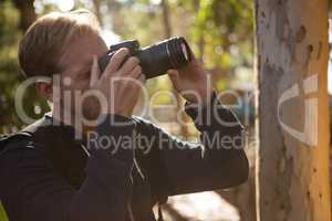 Man using dslr camera in the forest