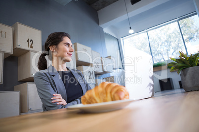 Thoughtful female executive sitting at desk