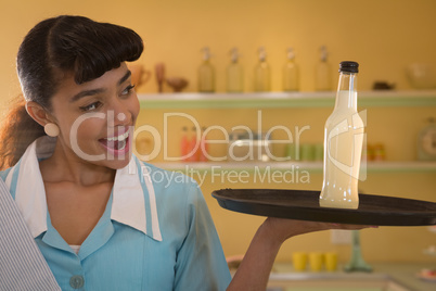 Waitress holding a tray with drink bottle
