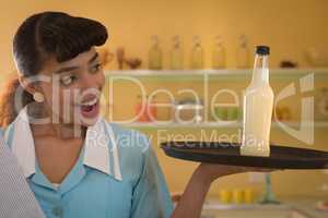 Waitress holding a tray with drink bottle