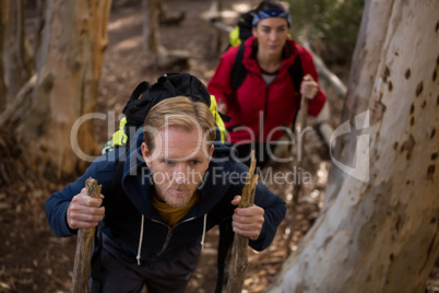 Hiker couple treading in forest